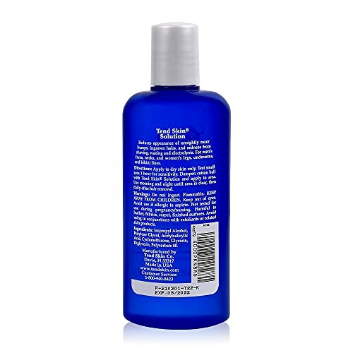 Back view of a blue bottle of Tend Skin Solution with text and barcode.